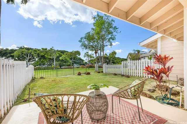 a view of a wooden dinning table and chairs in patio