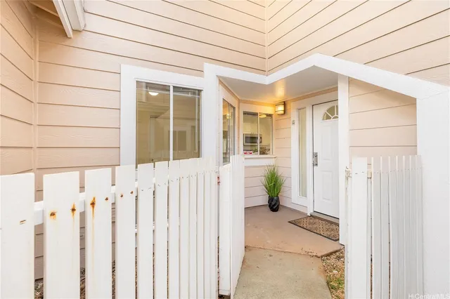 a view of a house with wooden fence