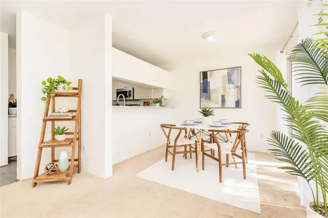 a view of a dining room with furniture and a potted plant