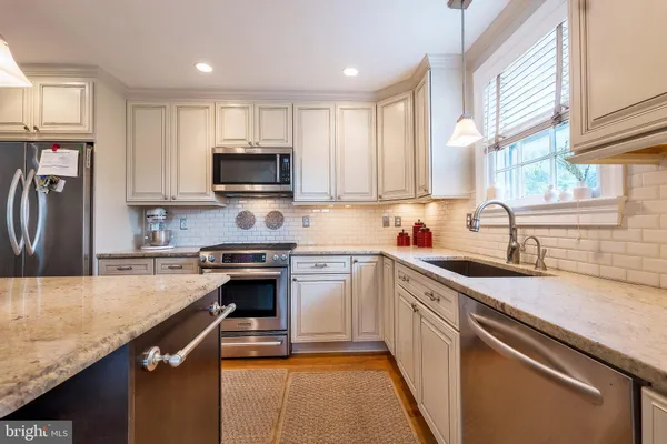 a kitchen with a sink stove and refrigerator
