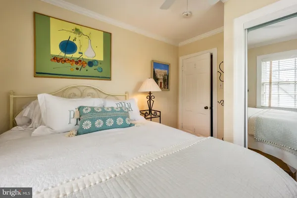 a bedroom with a bed and a painting on the wall