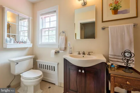 a bathroom with a sink toilet and mirror