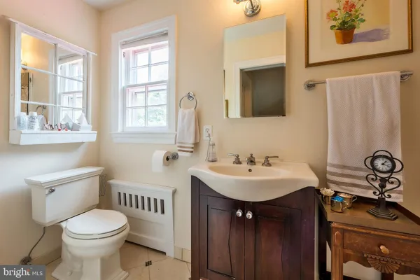 a bathroom with a sink toilet and mirror