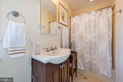 a bathroom with a sink a mirror and a shower