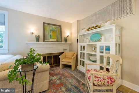 a bedroom with a bed a table and chair