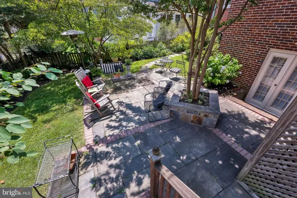 a view of a backyard with sitting area and garden