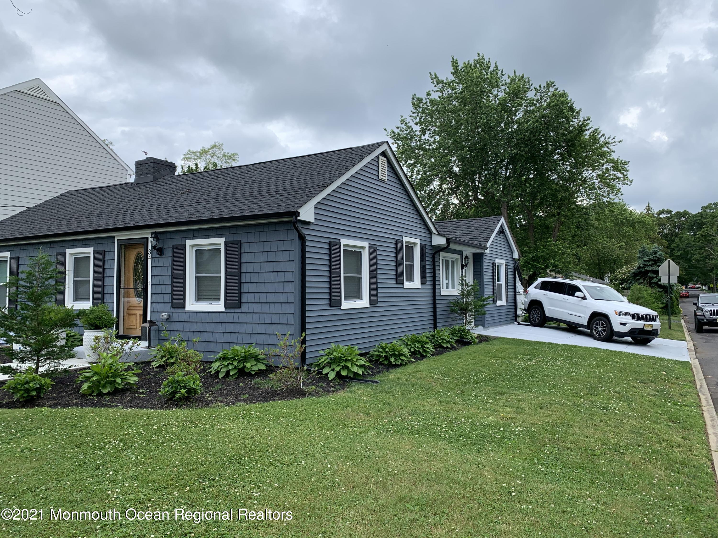 34 Forrest Avenue Rumson, NJ 07760 - Photo 2 of 22 a front view of a house with a garden