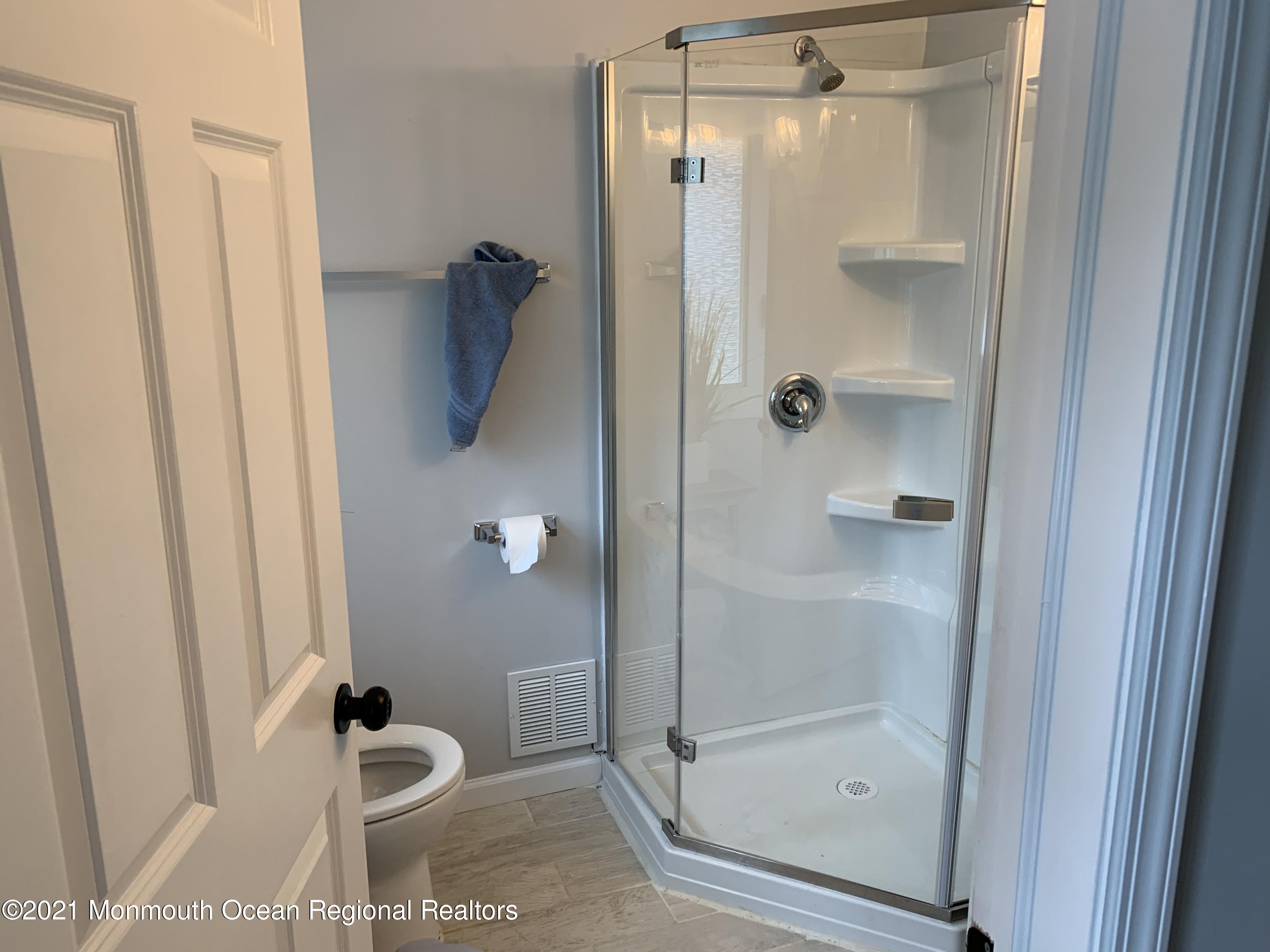 34 Forrest Avenue Rumson, NJ 07760 - Photo 16 of 22 a bathroom with a glass shower door