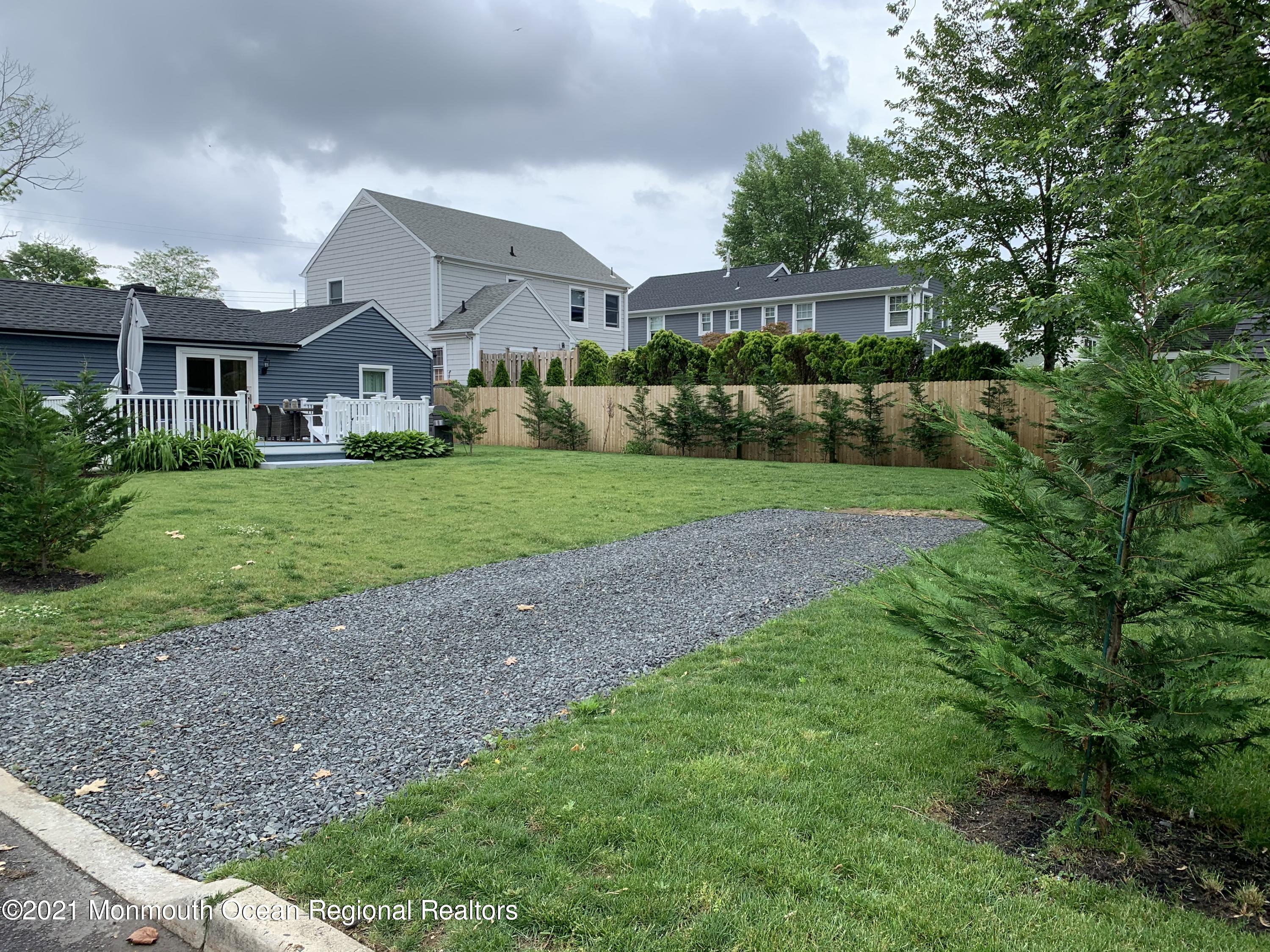 34 Forrest Avenue Rumson, NJ 07760 - Photo 20 of 22 a front view of a house with a yard and garage