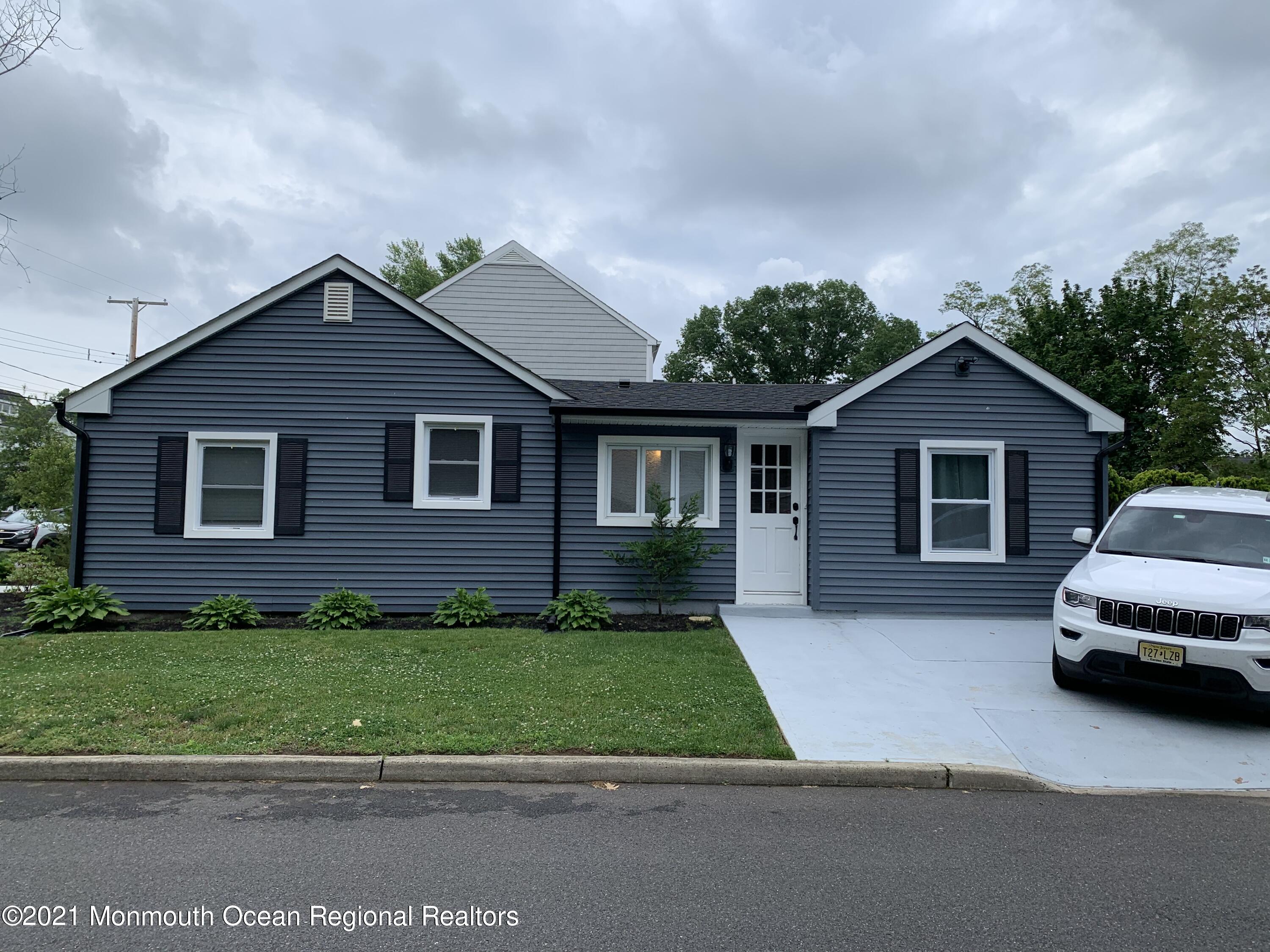 34 Forrest Avenue Rumson, NJ 07760 - Photo 3 of 22 a car parked in front of a house with a yard