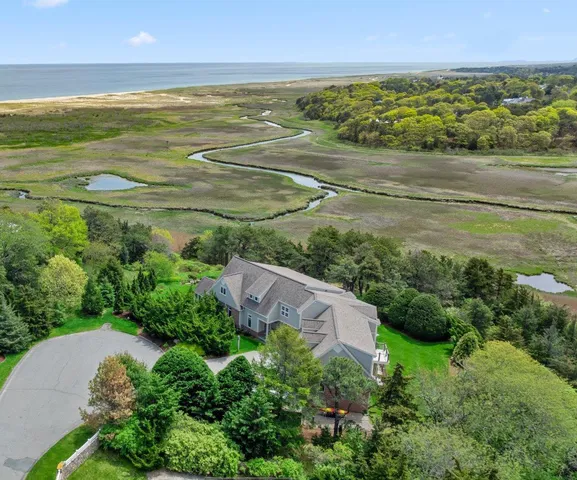 an aerial view of a house with a yard