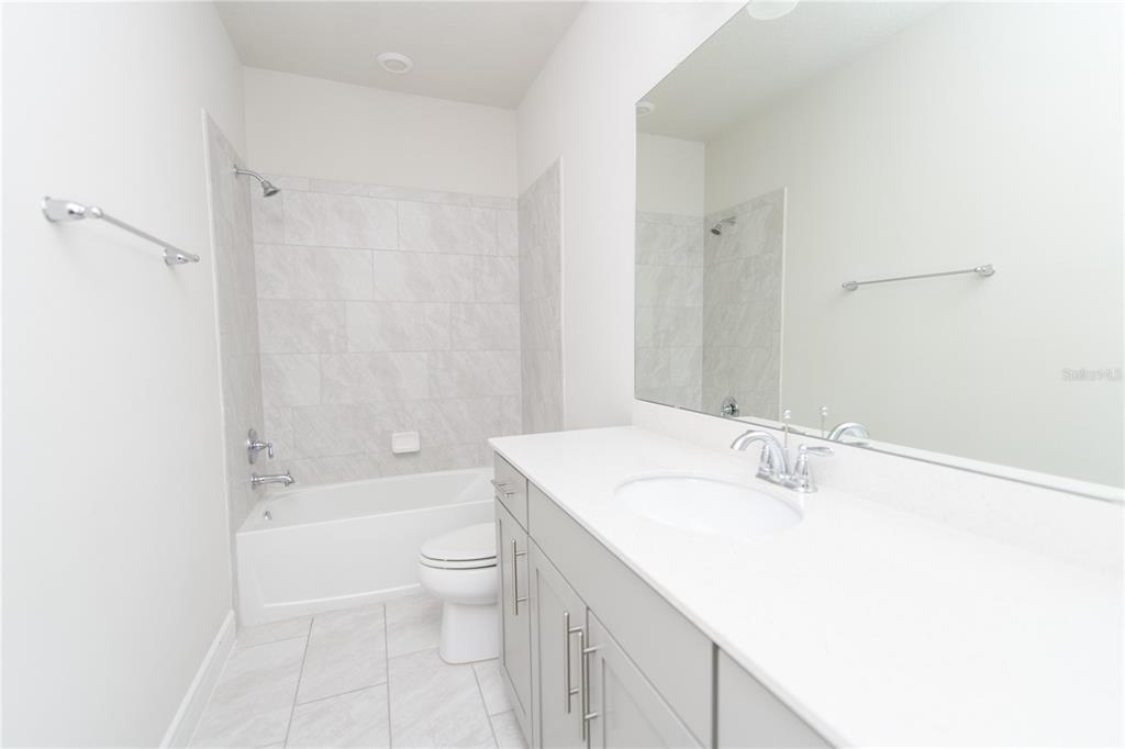 10746 Pahokee Beach Place Orlando, FL 32827 - Photo 32 of 67 a bathroom with a sink a toilet and shower
