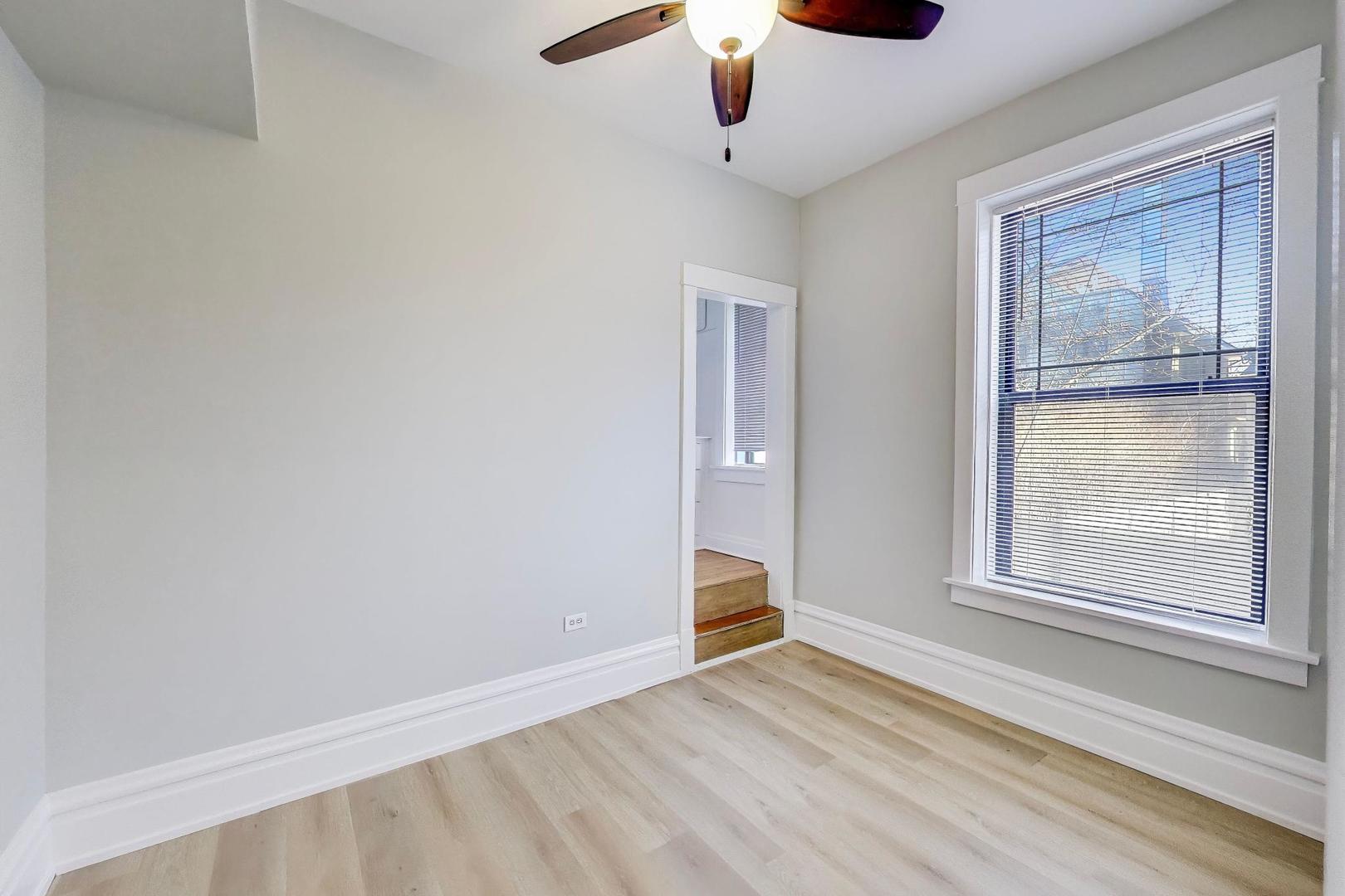 2114 West Byron Street, Unit 1 Chicago, IL 60618 - Photo 19 of 23 a view of an empty room with a window