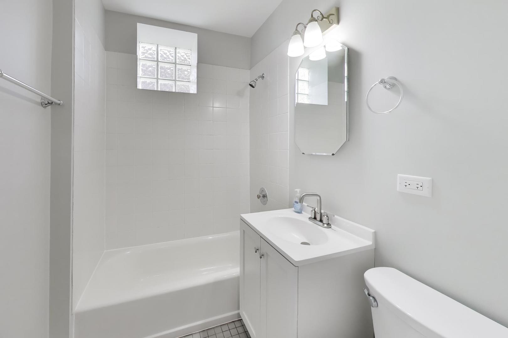 2114 West Byron Street, Unit 1 Chicago, IL 60618 - Photo 21 of 23 a bathroom with a sink a toilet and shower