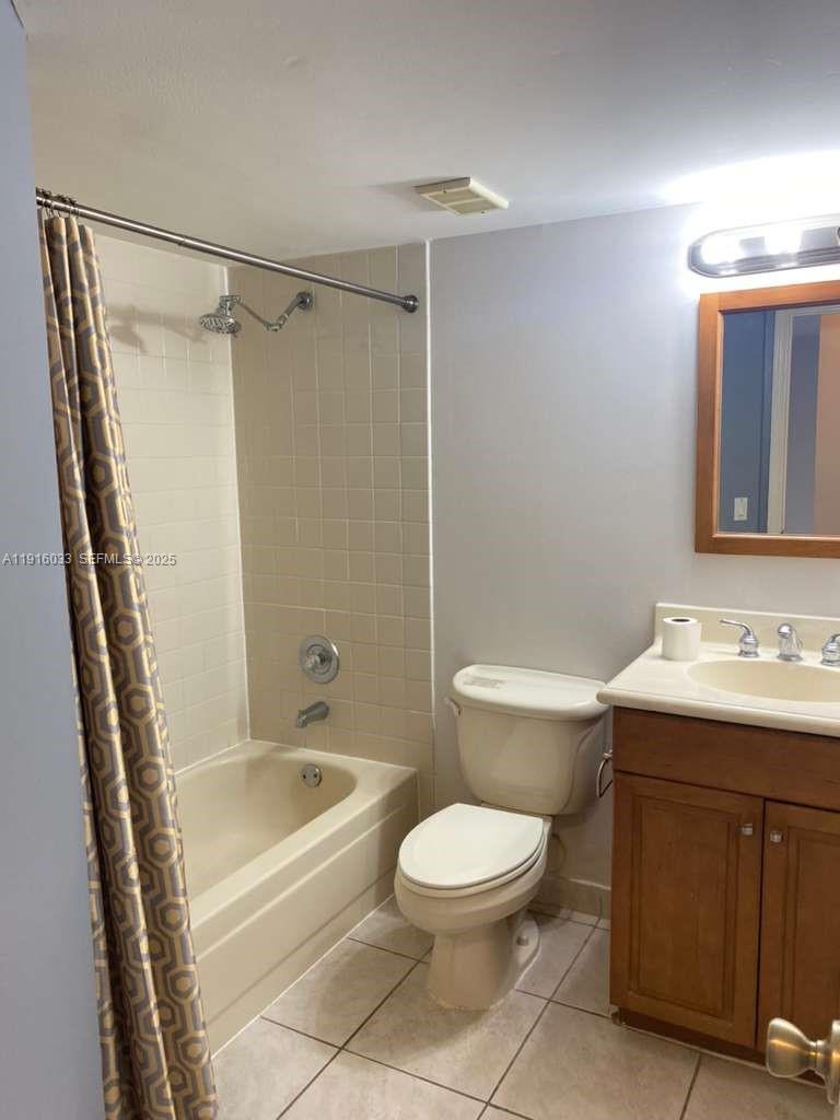 8901 Wiles Road, Unit 103 Coral Springs, FL 33067 - Photo 14 of 14 a bathroom with a sink a toilet and a bathtub