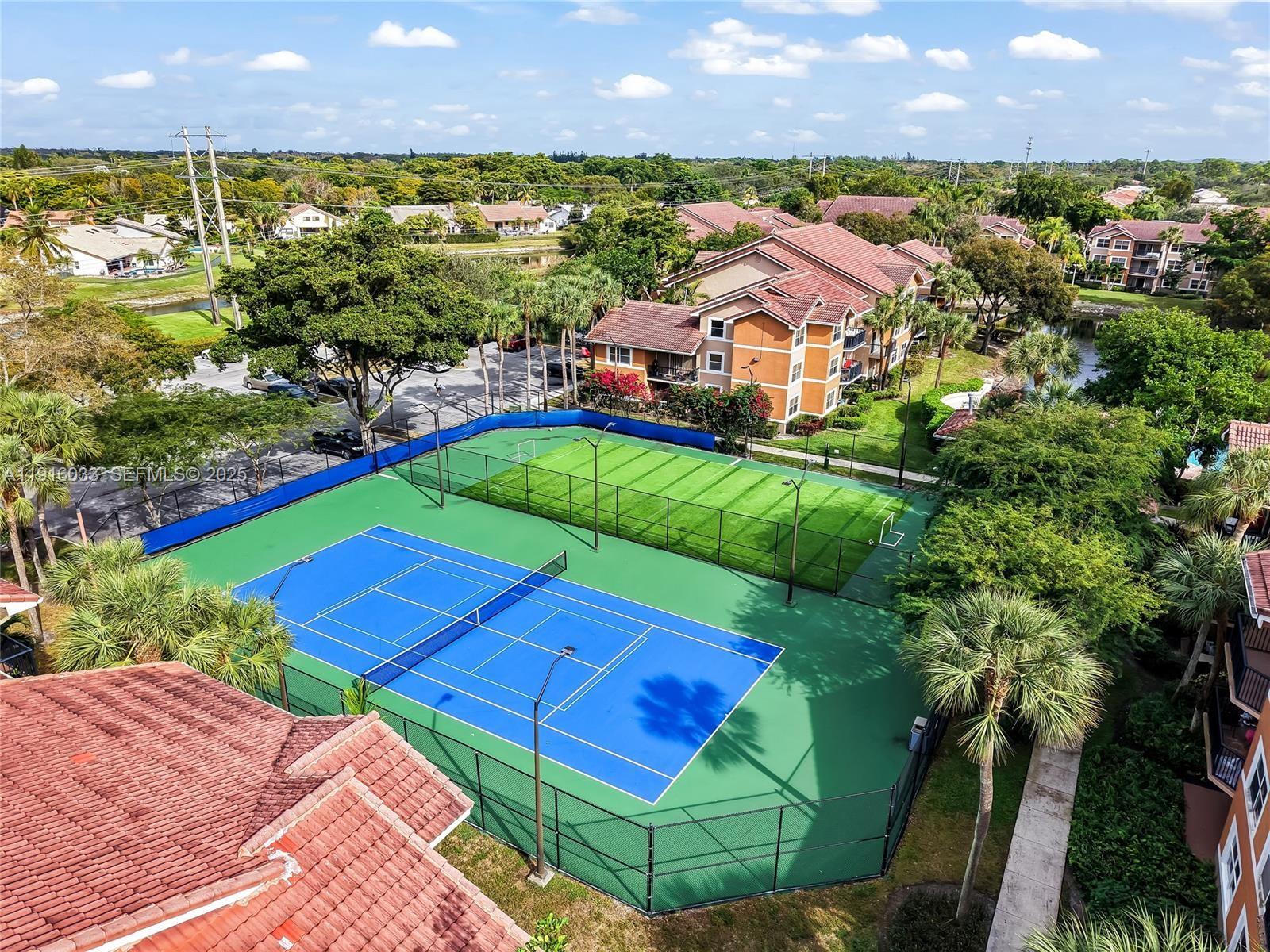 8901 Wiles Road, Unit 103 Coral Springs, FL 33067 - Photo 2 of 14 an aerial view of a house with a yard and lake view