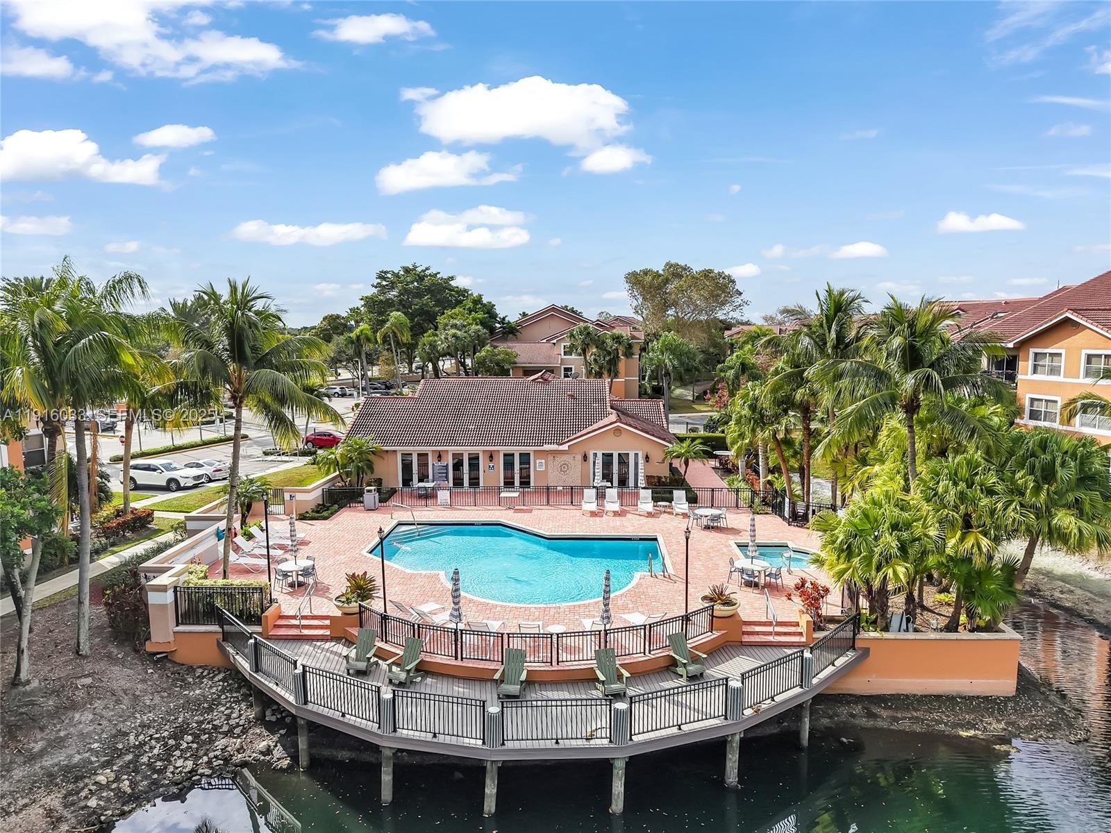8901 Wiles Road, Unit 103 Coral Springs, FL 33067 - Photo 3 of 14 a view of a chairs and table in a patio