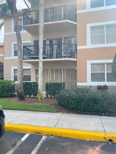 8901 Wiles Road, Unit 103 Coral Springs, FL 33067 - Photo 5 of 14 a view of a swimming pool with a garden and plants