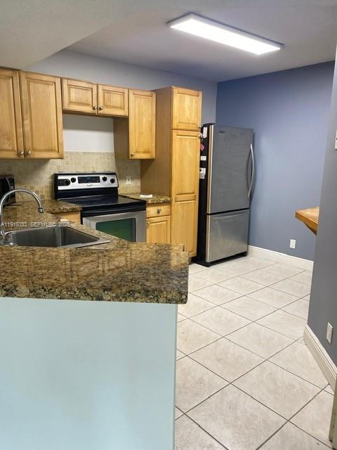 8901 Wiles Road, Unit 103 Coral Springs, FL 33067 - Photo 8 of 14 a kitchen with a refrigerator a stove and a sink