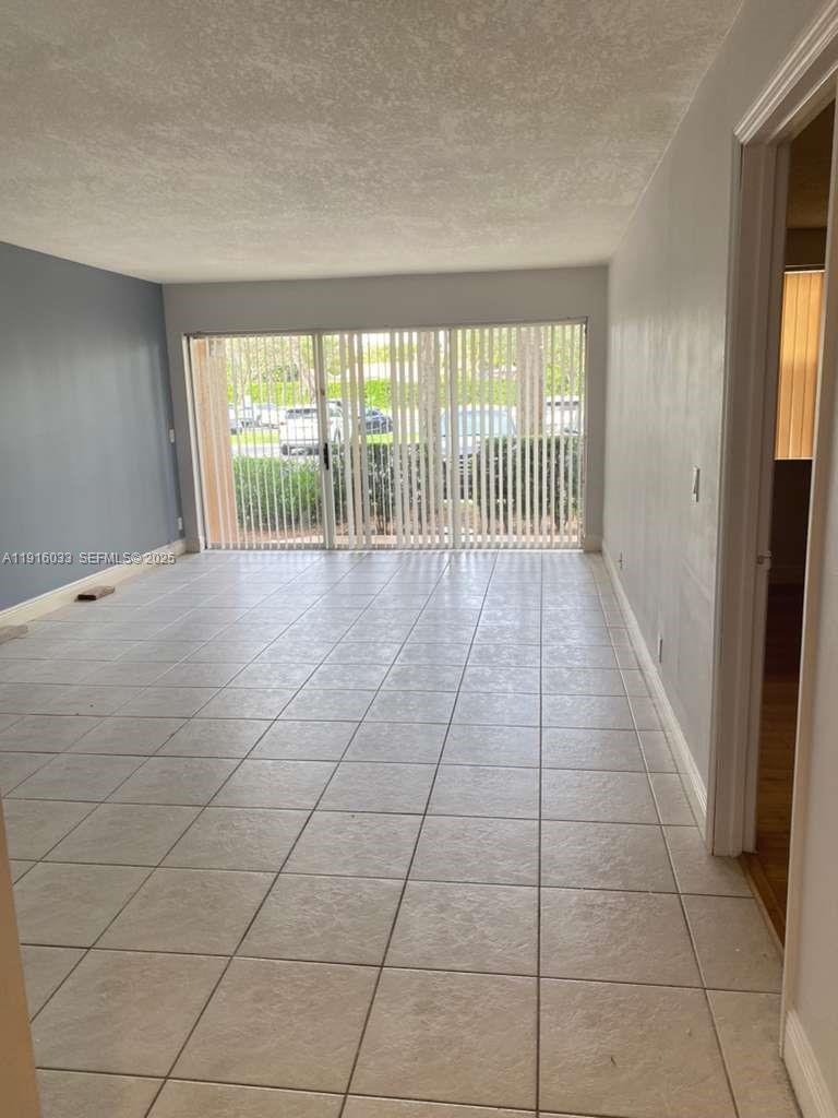 8901 Wiles Road, Unit 103 Coral Springs, FL 33067 - Photo 10 of 14 a view of an empty room with a window