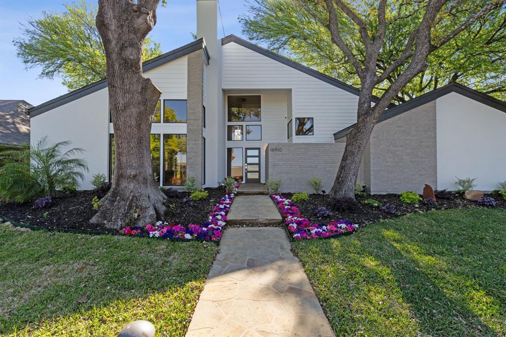 Mid-century inspired home featuring brick siding and a front yard