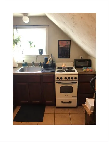 a kitchen with a stove a sink and a microwave