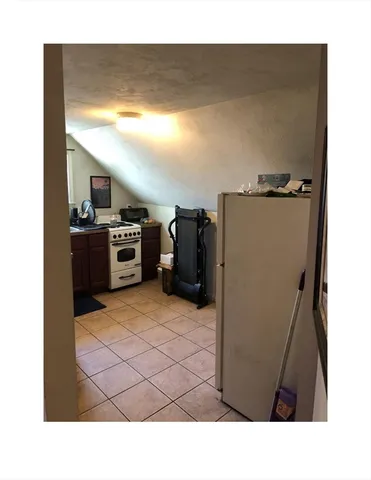 a open kitchen with refrigerator and stove