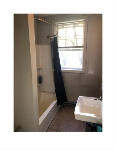 a bathroom with a sink a bath tub and a shower