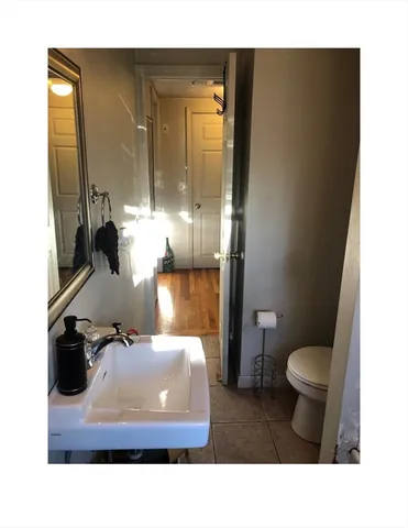 a bathroom with a sink toilet and mirror