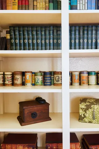 a living room with furniture a flat screen tv and a large window