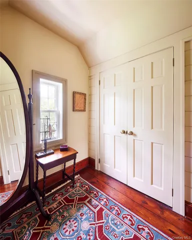 a view of hallway with wooden floor