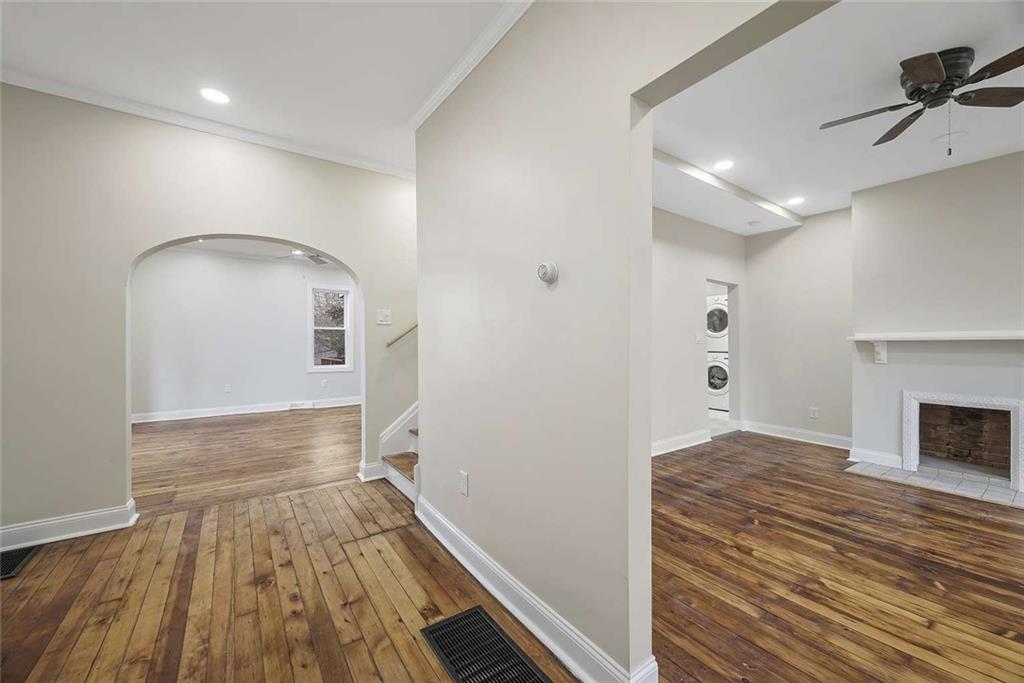 1617 West 9th Street Beaver Falls, PA 15010 - Photo 11 of 43 a view of a hallway with wooden floor and a fireplace
