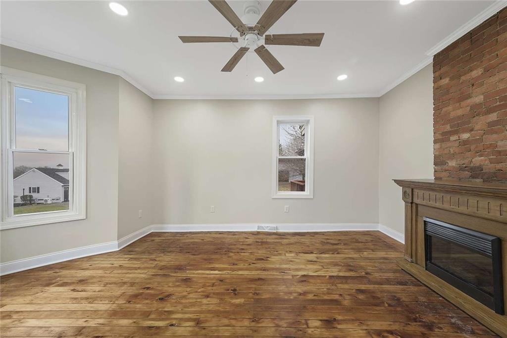 1617 West 9th Street Beaver Falls, PA 15010 - Photo 12 of 43 a view of an empty room with window and a fireplace