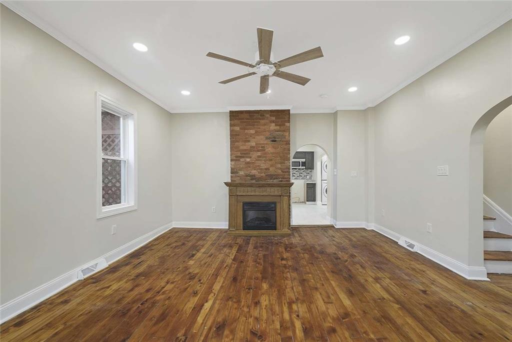 1617 West 9th Street Beaver Falls, PA 15010 - Photo 13 of 43 a view of a livingroom with a fireplace a ceiling fan and windows