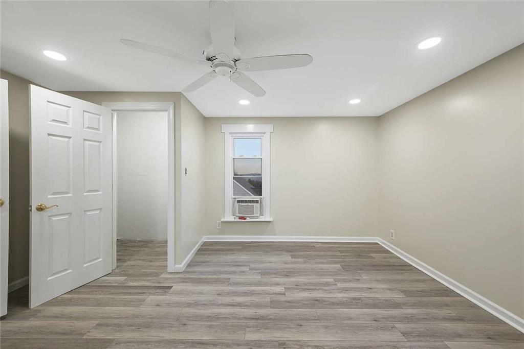 1617 West 9th Street Beaver Falls, PA 15010 - Photo 30 of 43 an empty room with wooden floor and windows