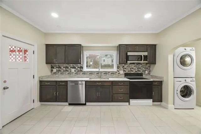 a large kitchen with a stove sink and cabinets