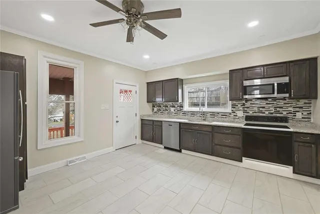 a view of a kitchen with a sink and a window