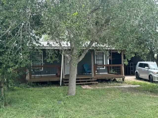 a view of a house with backyard and sitting area