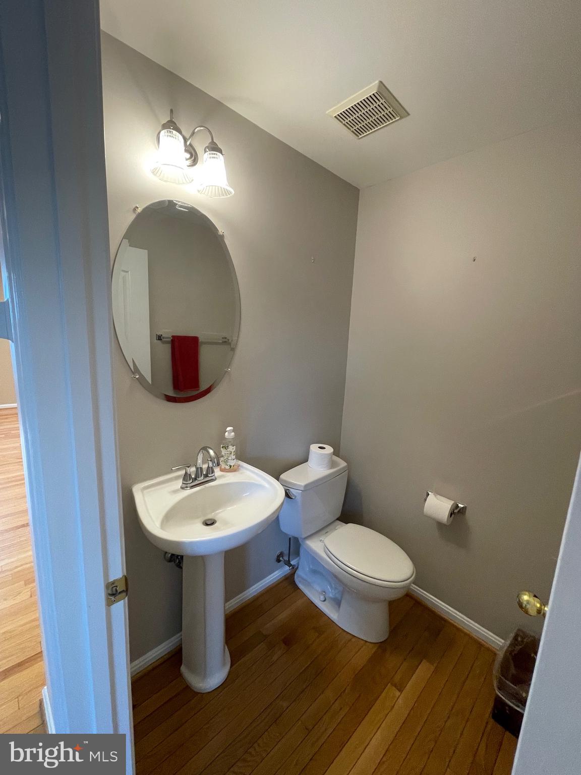 12968 Wood Cres Circle Herndon, VA 20171 - Photo 17 of 33 a bathroom with a toilet sink and mirror