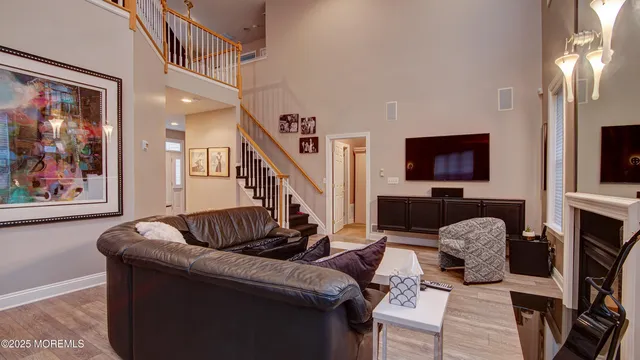 a living room with furniture fireplace and flat screen tv