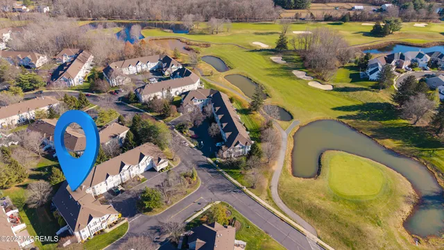 an aerial view of a swimming pool patio and outdoor seating