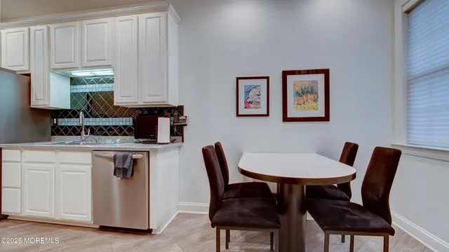 a kitchen with a table chairs and a refrigerator