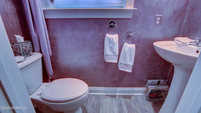 a bathroom with a sink a toilet a mirror and vanity