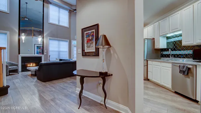 a living room with furniture and a kitchen view
