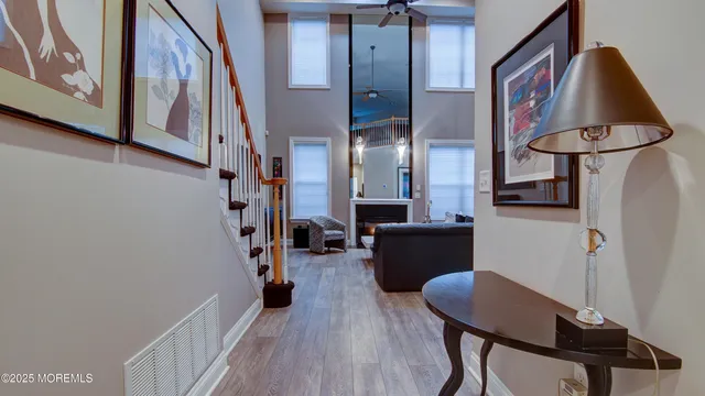 a view of a hallway with furniture and wooden floor