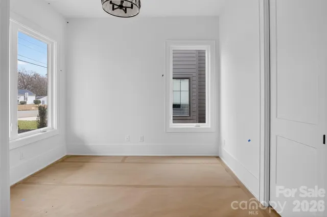 a view of an empty room with windows