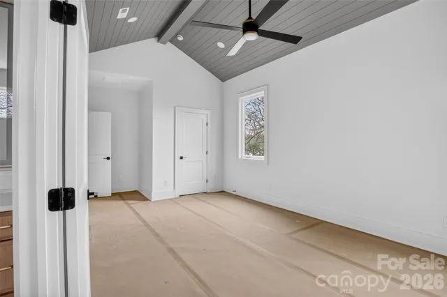 a spacious bathroom with a granite countertop sink and a mirror