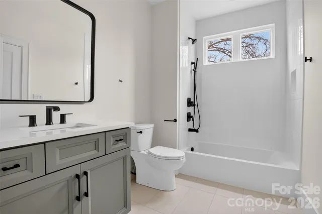 an empty room with a window and a ceiling fan