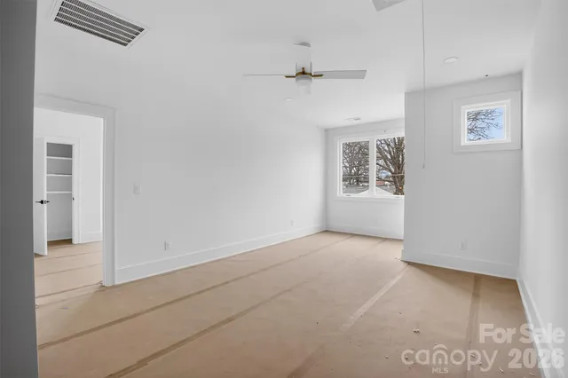 an empty room with ceiling fan