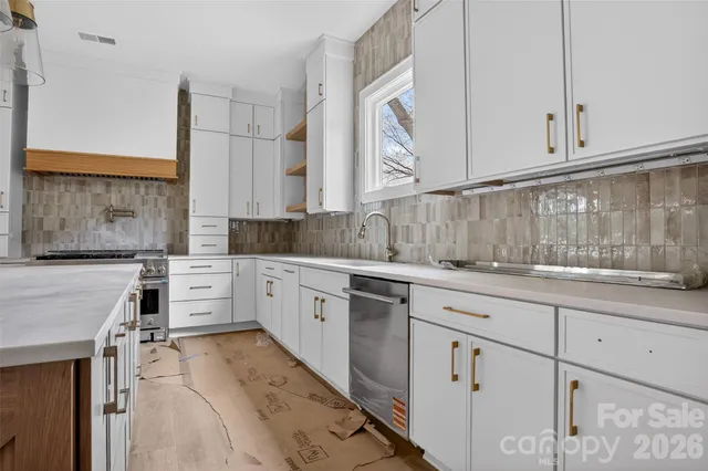 a kitchen with granite countertop a sink and cabinets